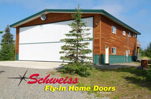 Residence with Attached Plane Storage with a Bifold Door