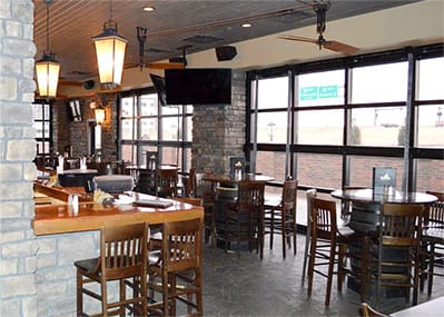 Interior view of Blarney Stone showing two custom Schweiss glass bifold doors that lead to their courtyard