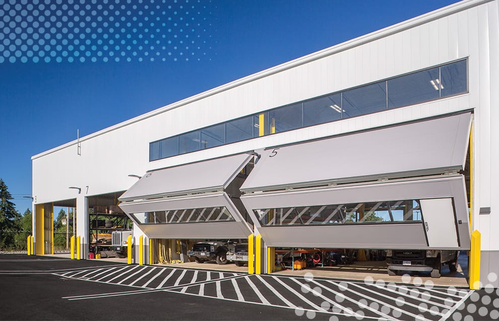 Wide view of multiple custom Schweiss bifold doors installed on BPA Maintenance headquarters facility