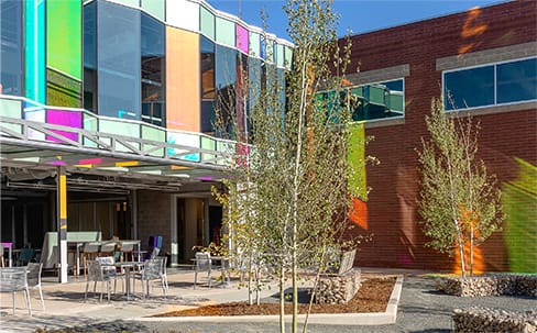 Custom colorful Schweiss hydraulic door fitted on an office space in Colorado