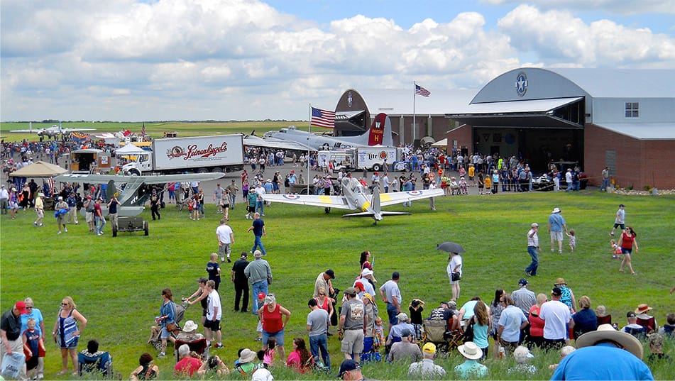 Crowds of people walking around the grounds of the Fagen WW2 Museum