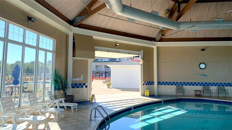 Interior view of Schweiss hydraulic door fitted on The Lodge at Geneva on the Lake for the indoor pool shown in the open position