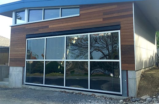 Rightside view of custom Schweiss glass hydraulic door installed on a garage in Pennsylvania