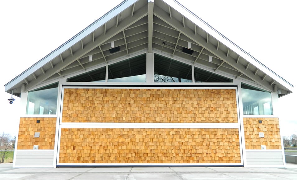 Exterior view of Schweiss bifold door fitted on Hamilton College boathouse shown closed