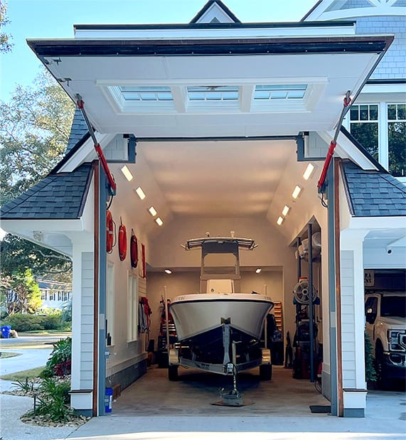 Closeup view of Schweiss designer hydraulic door with custom gabled end fitted on a home in Charleston shown open