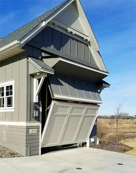 Custom Schweiss bifold door fitted on an RV garage in North Oaks, MN shown half open