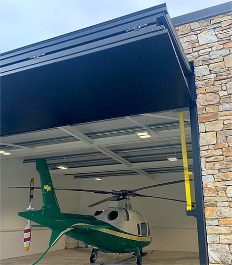 Schweiss bifold door installed on helicopter hangar in Ireland shown fully opened