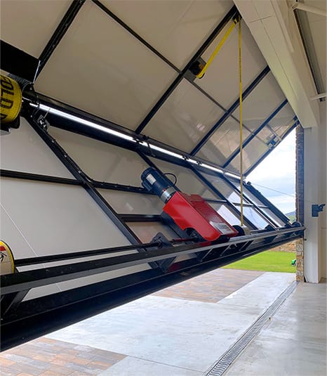 Interior view of Schweiss bifold door fitted on helicopter hangar in Ireland shown opening