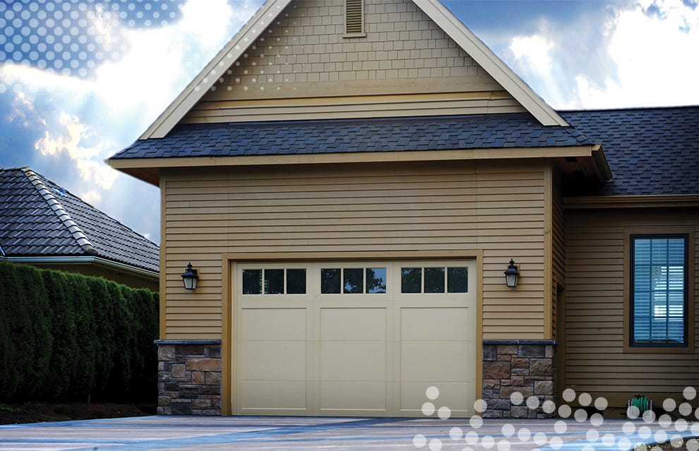 Custom Schweiss bifold door tall enough to store an RV fitted on a garage shown in the closed position