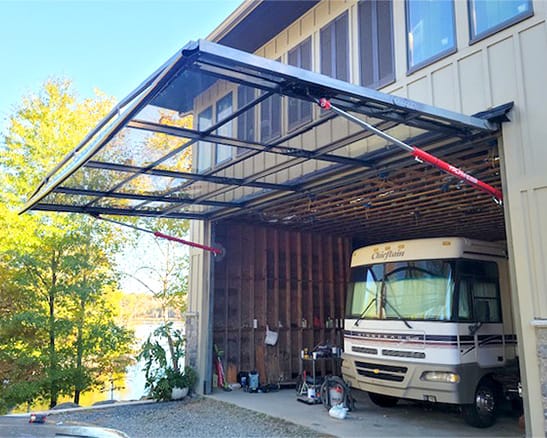 Custom Schweiss glass hydraulic door installed on Jeff LeVie's RV garage in North Carolina shown open