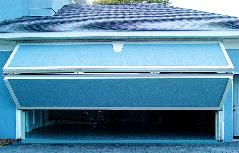 Frontal view of custom Schweiss bifold door with matching cladding fitted on a garage