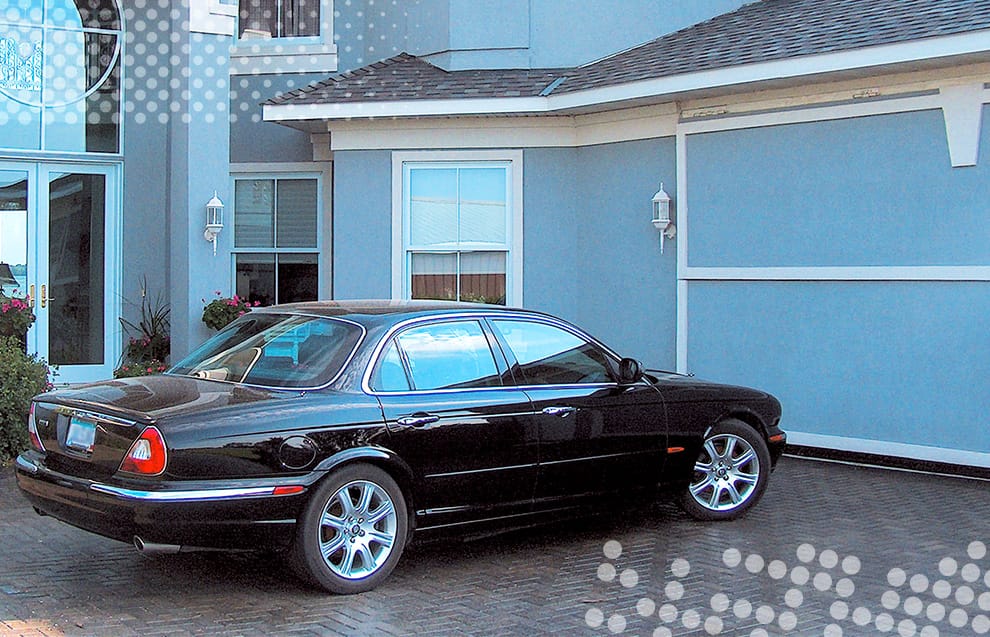 Car parked in front of garage fitted with custom Schweiss bifold door