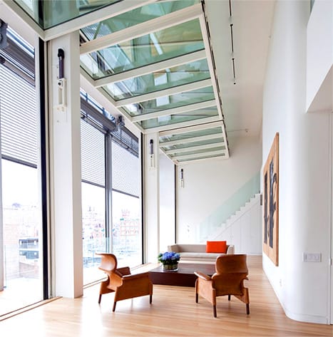 Multiple Schweiss bifold doors lining the windows of Metal Shutter House in the open position