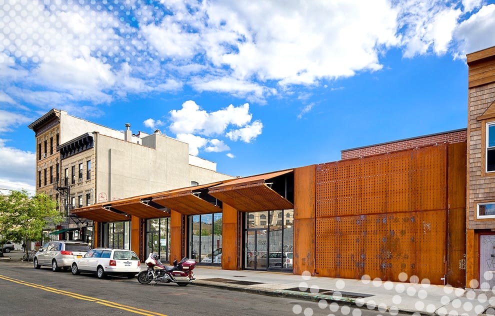 Multiple Schweiss bifold doors used for security on a storefront in New York