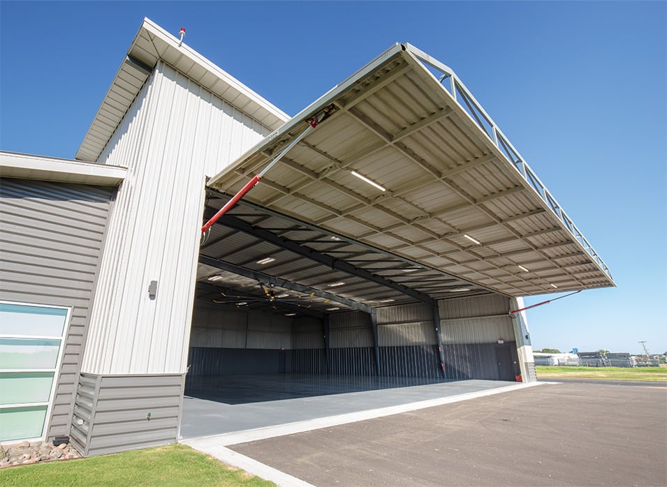 Exterior view of open Schweiss hydraulic door fitted on Prime Metal Building & Components new hangar