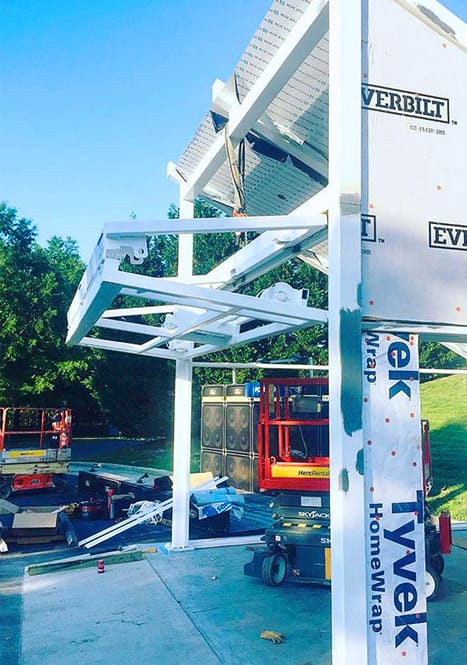 Frame of a Schweiss bifold door being installed on a Raven Show Container