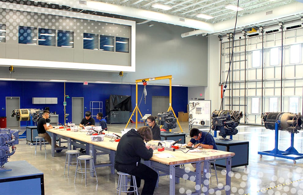 Students sitting in classroom fitted with Schweiss bifold door at Sterling Aviation HS