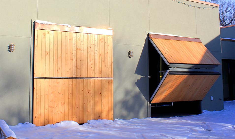 Exterior view of Struthers' garage fitted with multiple custom Schweiss bifold doors