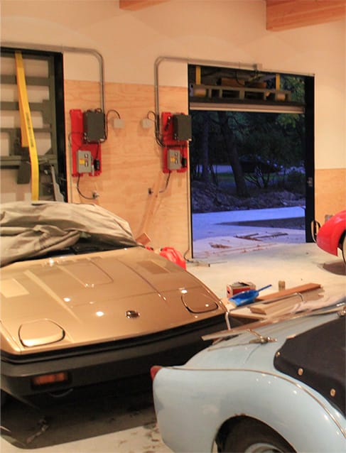 Interior view of Struthers' garage fitted with a custom Schweiss bifold door which stores his classic British cars