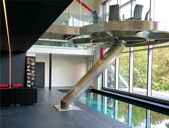 Dining table is cantilevered infront of hydraulic glass door