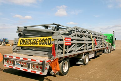 Schweiss door loaded on green semi truck ready for delivery