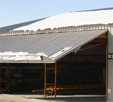 Hydraulic door truss prevents snow from sliding off door when open