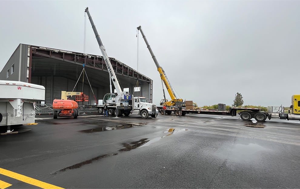 Schweiss Bifold being lifted into place on a construction