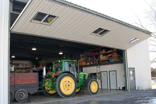 Well-built Schweiss shop Doors can store equipment among other vehicles 