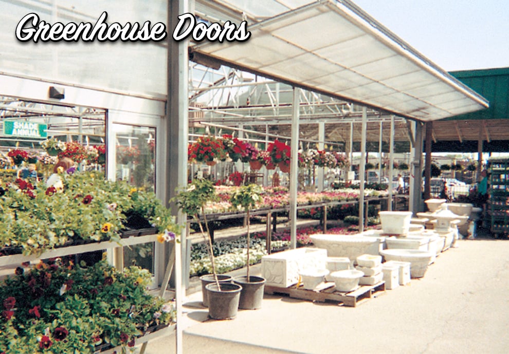 Natural light allowed into greenhouse through translucent cladding on these Schweiss doors