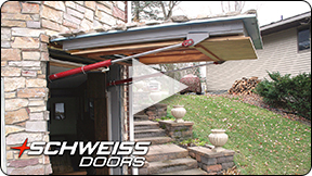 A Schweiss Hidden Hydraulic door matches home exterior