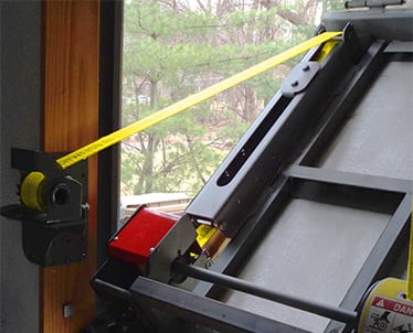 Closeup view of Schweiss strap latches installed on a bifold door